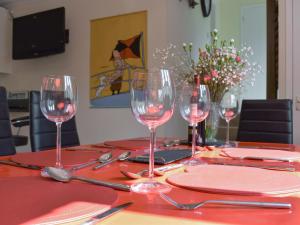 a table with wine glasses on a red table cloth at Elizabeth House in Bampton