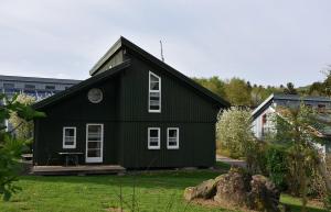 a black house with white windows on a yard at Ferienhaus Nr 8A2, Feriendorf Hagbügerl, Bayr Wald in Waldmünchen