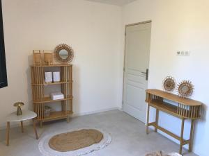 a room with a door and a table and a rug at Isolella à 50 m de la plage in Pietrosella