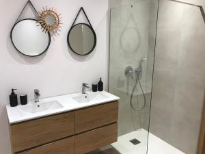a bathroom with a sink and a shower at Isolella à 50 m de la plage in Pietrosella +16 photos