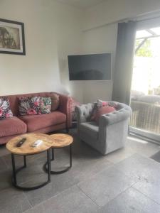 a living room with two couches and a coffee table at Guesthouse ML in Hillegom