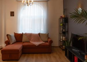 a living room with a couch in front of a window at Villa ANMA in Bucharest