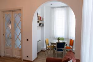 a dining room with an archway and a table and chairs at Villa ANMA in Bucharest