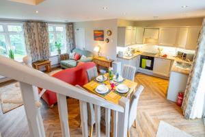 a kitchen and living room with a table and chairs at Brackenhurst Cottage by Big Skies Cottages in West Runton