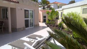a patio with lounge chairs and a house at EL Paraiso in La Pared