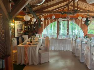 a dining room with white tables and white chairs at Park Hédervár in Hédervár