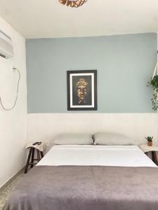 a bedroom with a large white bed in a room at Suíte Pontal in Arraial do Cabo