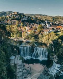 an aerial view of a waterfall in a city at Nurr in Jajce +11 photos