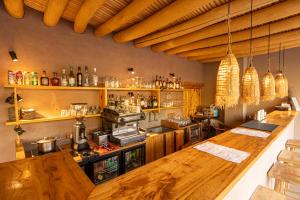 a large kitchen with a counter and a bar at Dolkhar Resort in Leh