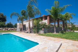a house with a swimming pool in front of a house at Cubo's Finca La Sierra in Alhaurín el Grande