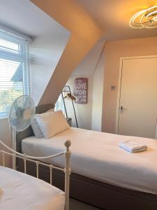 two beds in a room with a attic at The Boho - 4 min walk to beach & town in Bournemouth