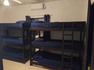 a group of bunk beds in a room at Hostel Oásis in Itanhaém