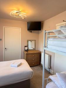 a bedroom with two bunk beds and a mirror at The Boho - 4 min walk to beach & town in Bournemouth