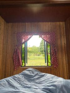 a bedroom with a window with a view of a field at Hà Giang Lake View House in Lan Hung +24 photos