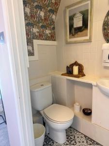 a bathroom with a toilet and a sink at The Boho - 4 min walk to beach & town in Bournemouth