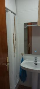 a bathroom with a sink and a mirror at Torremar in Benicarló +27 photos