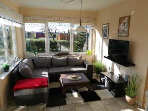 a living room with a couch and a table at Zur Schwedenschanze 3 in Hohen Wieschendorf