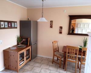 a kitchen and dining room with a table and a refrigerator at Zur Schwedenschanze 3 in Hohen Wieschendorf