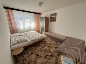 a small bedroom with a bed and a window at U Milušky in Ždiar +9 photos