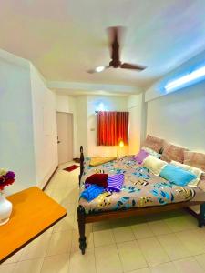 a bedroom with a bed and a couch at Serene Guest House ll 2 Ac Rooms ll WiFi ll Tv ll Garden in Khandala