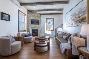 a living room with a couch and chairs and a fireplace at Historic Homestead with Pond and Teton Range Views in Tetonia