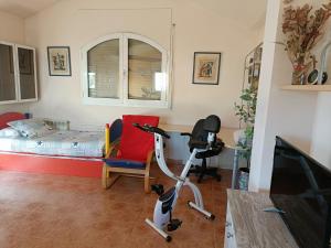 a room with a bedroom with a bed and a desk at Casa con jardín y piscina privada. in Santa Eulalia de Ronsaná