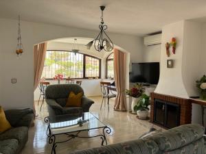 a living room with a couch and a fireplace at Casa Leon Cabo de Palos in Cabo de Palos