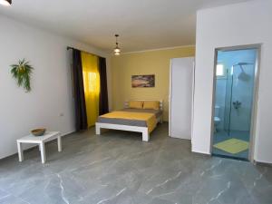 a bedroom with a bed and a bathroom with a shower at Magawish Hurghada Studio 7 in Hurghada +49 photos