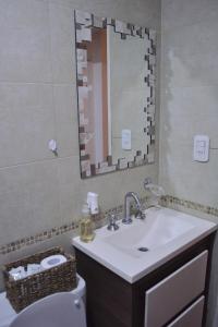 ein Badezimmer mit Waschbecken, Spiegel und Toilette in der Unterkunft Ruka Depto Alquiler temporario en Mercedes in Mercedes