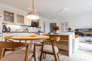 een keuken en eetkamer met een tafel en stoelen bij App 22, Strandresidenz Dünenperle in Kühlungsborn