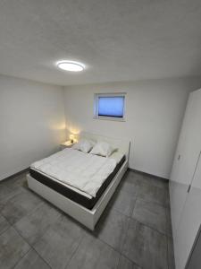 a bedroom with a bed in a white room at FeWo Morgenstern in Bad Wildungen