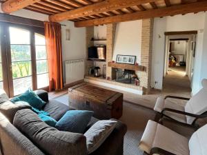 a living room with a couch and a fireplace at Villa Massignano in Gualdo di Macerata +23 photos