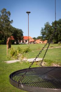 a swing in a park with a field of grass at Auszeithof Otersen - Ferienwohnung 1 in Kirchlinteln +9 photos