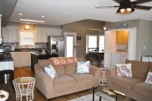 a living room with two couches and a kitchen at Carmels by the Sea home in Holden Beach +62 photos