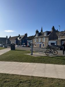a bike parked on the grass in a park at The Milton Accommodation in Elgin