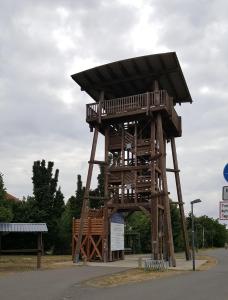 a wooden tower with a roof on the side of a road at Ferienhaus am Geiseltalsee in Braunsbedra