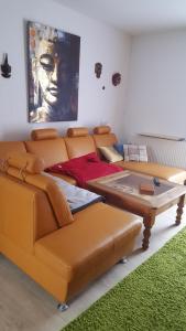 a living room with a couch and a table at Ferienhaus am Geiseltalsee in Braunsbedra