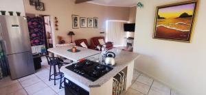 a kitchen with a stove and a counter top at The Third Dolphin in Herolds Bay