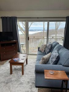a living room with a blue couch and a coffee table at Condo,Full Kitchen, ShantyCreek, Beach Club, Private Pool in Bellaire