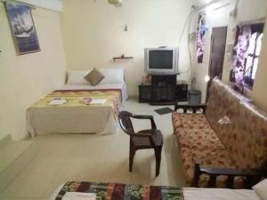a room with two beds and a tv and a couch at Manimalar guest in Colombo +35 photos