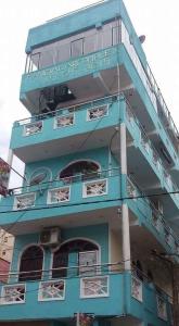 a blue building with a sign on it at Manimalar guest in Colombo