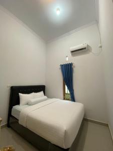 Postel nebo postele na pokoji v ubytování Homestay Telage Bulan