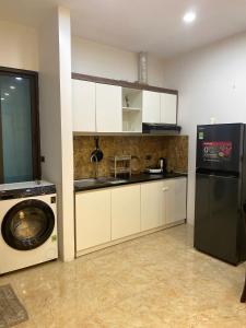 a kitchen with a washing machine and a washer at MINGO House BA ĐÌNH in Hanoi +7 photos