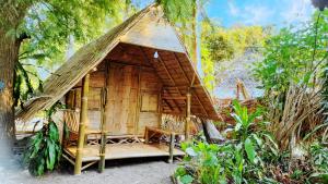 a small hut with a porch in a forest at Bamboo Village in Ban Tai +44 photos