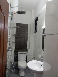 a small bathroom with a toilet and a sink at Luxurious Spacious 3bedroom apartment Nyali Mombasa in Mombasa