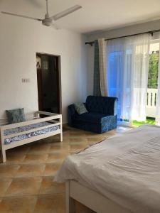 a living room with a bed and a couch at Luxurious Spacious 3bedroom apartment Nyali Mombasa in Mombasa