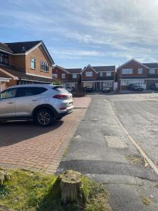 a car parked in a parking lot in front of houses at Budget Room in Wolverhampton in Coseley