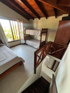 a room with two bunk beds and a chair at Complejo un Mundo Aparte in Mar de Ajó +86 photos