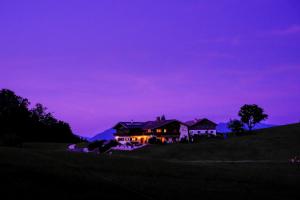 a house on a hill with a purple sky at Gästehaus Lärcheck Berchtesgaden FeWo Gipfelzauber in Berchtesgaden +7 photos