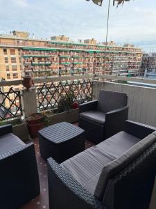 a balcony with chairs and tables on a building at #Punto FM 7# in Marghera